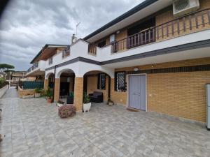 a large house with a patio and a building at Greta family house in Rome