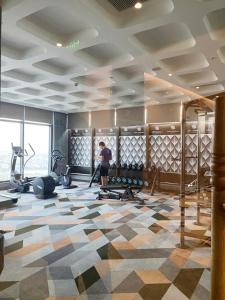 a room with a gym with a person in it at APEC MANDALA Tuy Hòa in Liên Trì (4)