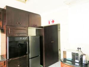 a kitchen with a stove and a refrigerator at HavenNest in Rustenburg +7 photos