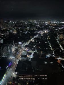 a city lit up at night with traffic at DG SUITES - Horizon 101 Tower 2 in Cebu City