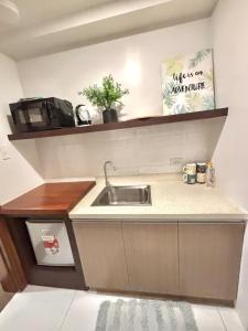a kitchen with a sink and a microwave at DG SUITES - Horizon 101 Tower 2 in Cebu City