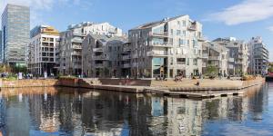 a group of buildings next to a body of water at Central Oslo Apartment with Private Balcony in Oslo