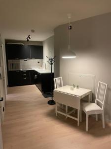 a kitchen and dining room with a table and chairs at Central apartment in Ålesund