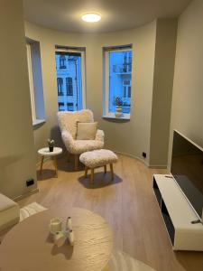 a living room with a chair and a table at Central apartment in Ålesund