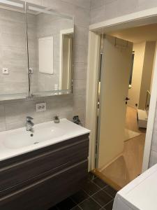 a bathroom with a sink and a mirror at Central apartment in Ålesund