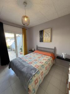 a bedroom with a bed and a sliding glass door at AwayDays - Casa con Piscina in Empuriabrava +25 photos