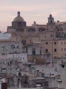 an old city with a large building in the background at Casa Libertà Spacious white scandidesign in Ostuni +61 photos