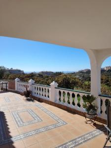 a balcony with a white railing and a view at Casa Paloma Blanca in Málaga