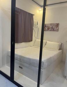 a reflection of a bedroom with a bed in a mirror at Mamitas Place, Royal Oceancrest Mactan in Lapu Lapu City +3 photos