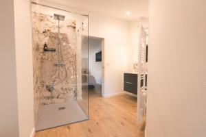 a shower with a glass door in a bathroom at Le Château de La Seigne près de Carcassonne in Villemoustaussou +90 photos