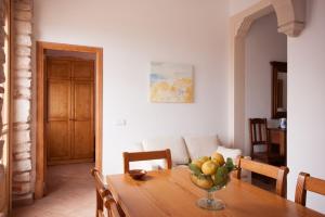 a dining room table with a bowl of fruit on it at Casa Maremar in Cala Figuera