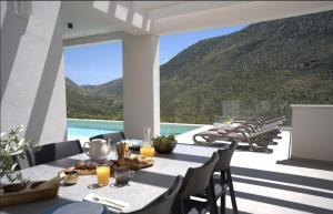 a dining room with a table and a view of a mountain at Luxury Villa Mandy - Split in Žrnovnica