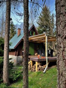 a house with a pergola on the porch at Kerekerdő Apartman - Szarvaskő in Szarvaskő +39 photos