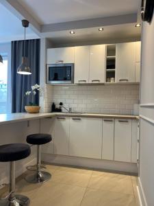 Kuchyňa alebo kuchynka v ubytovaní Airport Apartment Warszawa