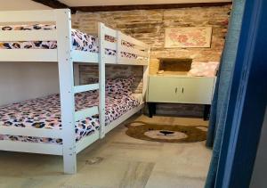 a room with two bunk beds in a room at Magnone Vacance - Gîte Belle Vue in Lavercantière