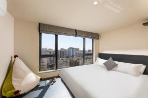 Postel nebo postele na pokoji v ubytování GTOOO Hotel