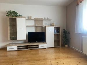 a living room with a tv on a entertainment center at Ferienhaus Wittig in Löbnitz