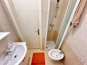 a bathroom with a sink and a toilet and a shower at Baia Piccola in Baia Verde +15 photos