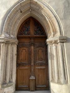 a wooden door in an archway in a building at The Three Sisters Hotel in Tallinn