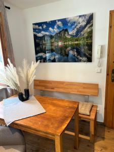 a table and bench in a room with a picture on the wall at Fewo Auszeit am Königssee in Schönau am Königssee