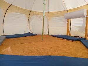 a tent with a pole in the middle at Tamar Land in Kalia