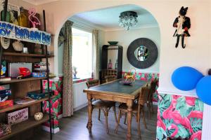 a dining room with a wooden table and chairs at Lakeland Lodge with private Hot Tub and fishing in Hatfield Peverel