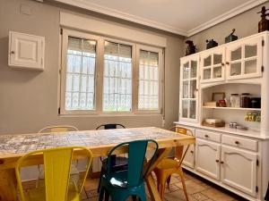 a kitchen with a wooden table and chairs at La Casa de Praves in Praves