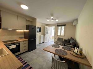 a kitchen with a table and a kitchen with a refrigerator at Leonidio Apartment Zenith-Nadir in Leonidion