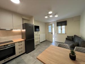 a kitchen and living room with a couch and a refrigerator at Leonidio Apartment Zenith-Nadir in Leonidion