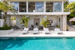 a villa with a swimming pool and a house at Villa Kohia, stunning sea views, breakfast, serviced daily, private dining service on request, North Chaweng in Nathon Bay