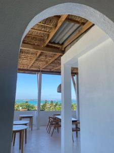 an archway of a restaurant with tables and chairs at KOMOREBI Weligama in Weligama