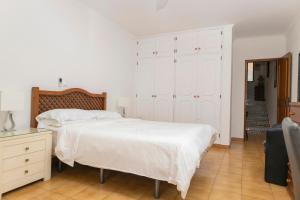 a bedroom with a large white bed and a dresser at Vila Van Gogh in Luz +19 photos
