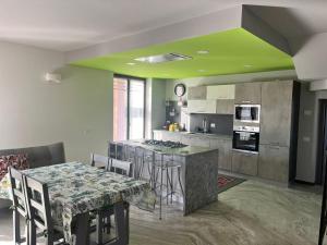a kitchen with a table with chairs and a counter top at Villa De Alberti in Vergiate