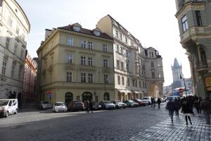 a city street with buildings and people walking on the street at Old Town Apartments Tyn in Prague