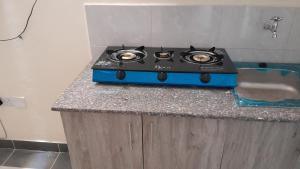 a blue stove sitting on a counter in a kitchen at MJ homes in Mtwapa