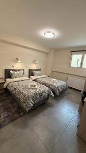 two beds in a bedroom with a window at Leonidio Apartment Zenith-Nadir in Leonidion +12 photos