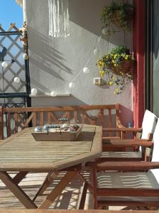 a wooden table and chairs on a patio at Breathe in Delphi - Spacious 3BR Apt with View in Delphi