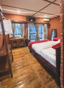 a bedroom with two beds and a desk at Tropical Escape - Patal Eco Villas in Rānīpauwa