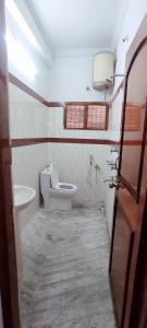 a bathroom with a toilet and a sink at Mahuri home stay in Visakhapatnam