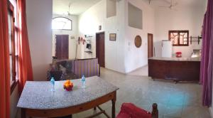 a living room with a table and a kitchen at Pro Luxor guest house in Luxor