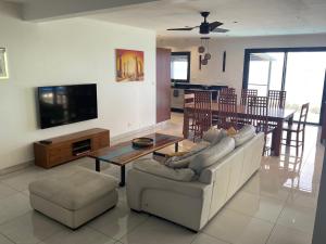 a living room with a couch and a table at Leu Panoramique in Saint-Leu