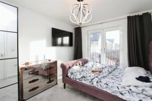 GreenhitheにあるFamily Friendly 4-Bedroomsのベッドとドレッサーと窓のある寝室 +1枚の写真