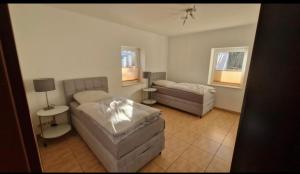 a living room with a bed and a couch at Zimmer am See mit Zugang in Zeuthen