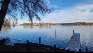 a lake with a wooden dock on the water at Zimmer am See mit Zugang in Zeuthen