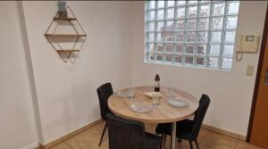 a dining room with a wooden table and chairs at Zimmer am See mit Zugang in Zeuthen