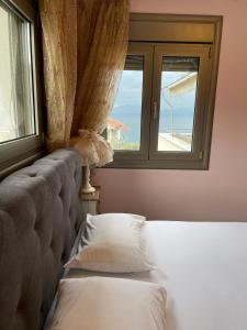a bedroom with a bed and a window at Seaside Boutique Villa in Volos