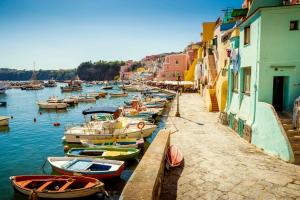 a group of boats are docked in a harbor at Corricella Hammok - Gioia Apartments in Procida