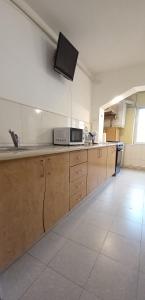 a kitchen with a counter with a microwave on the wall at Apartament C5 in Tulcea +5 photos
