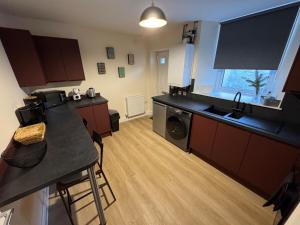 a kitchen with a table and a counter top at New cosy ground floor flat in Hawick