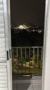 a view from a door of a balcony at night at Apto em Itapecerica da Serra in Itapecerica da Serra